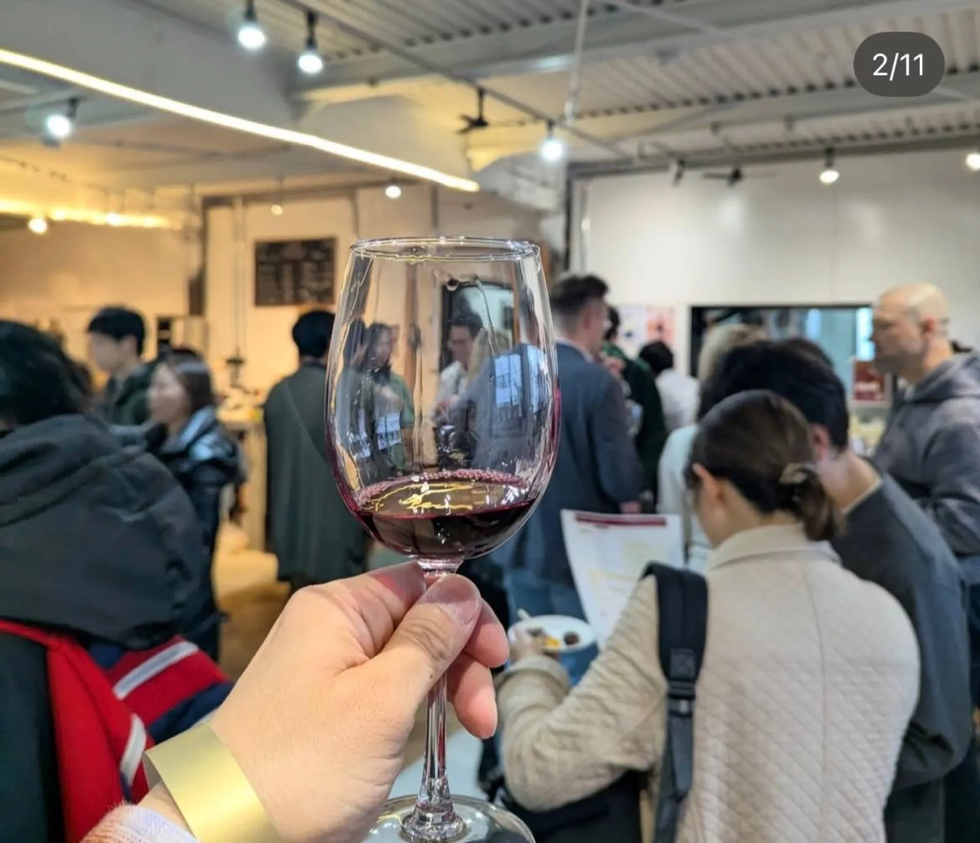 ワイングラス越しに見るイベント会場の賑わい